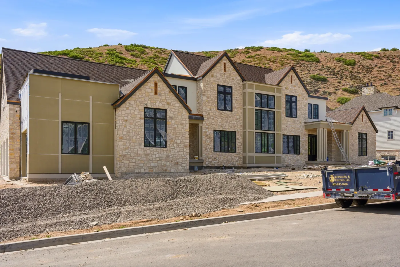 Front elevation of the Elk Ridge estate in stone and stucco against the Wasatch