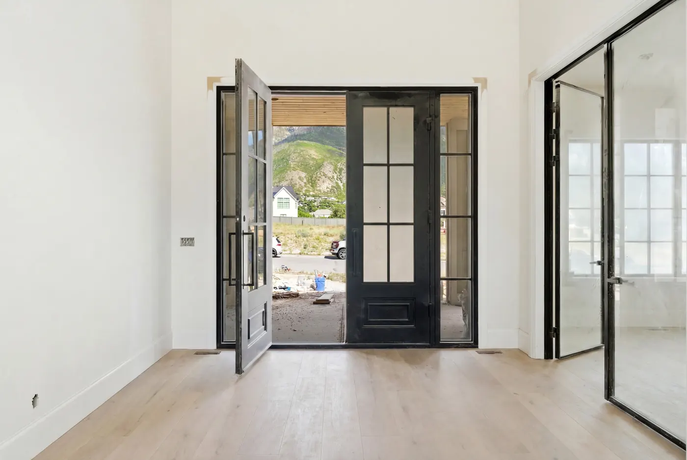 Entry with black glass doors framing the mountain view
