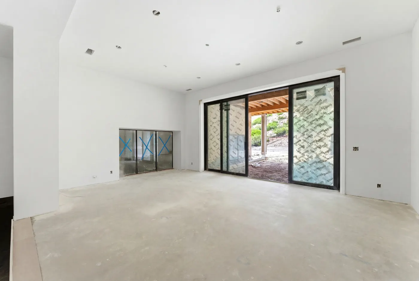 Lower-level sport and wellness space with sliding glass doors to the covered terrace